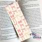 cardstock bookmark with a collection of pink coquette bows on a pastel yellow background by elle and dina design