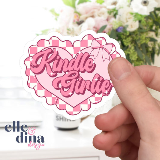 pink heart shaped sticker with ribbon bow and checkerboard ruffle detail with kindle girlie in decorative text by elle and dina design