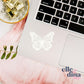 white butterfly sticker shown on a laptop designed by elle and dina design